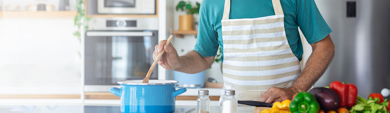 Person stirring pot in kitchen