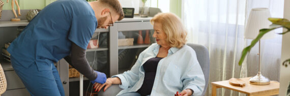 Nurse administering infusion therapy to older woman at home, showing the value of specialized training in home health care.