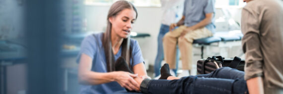 Occupational therapist working with a patient in the ED, illustrating the benefits of OT services in emergency care.