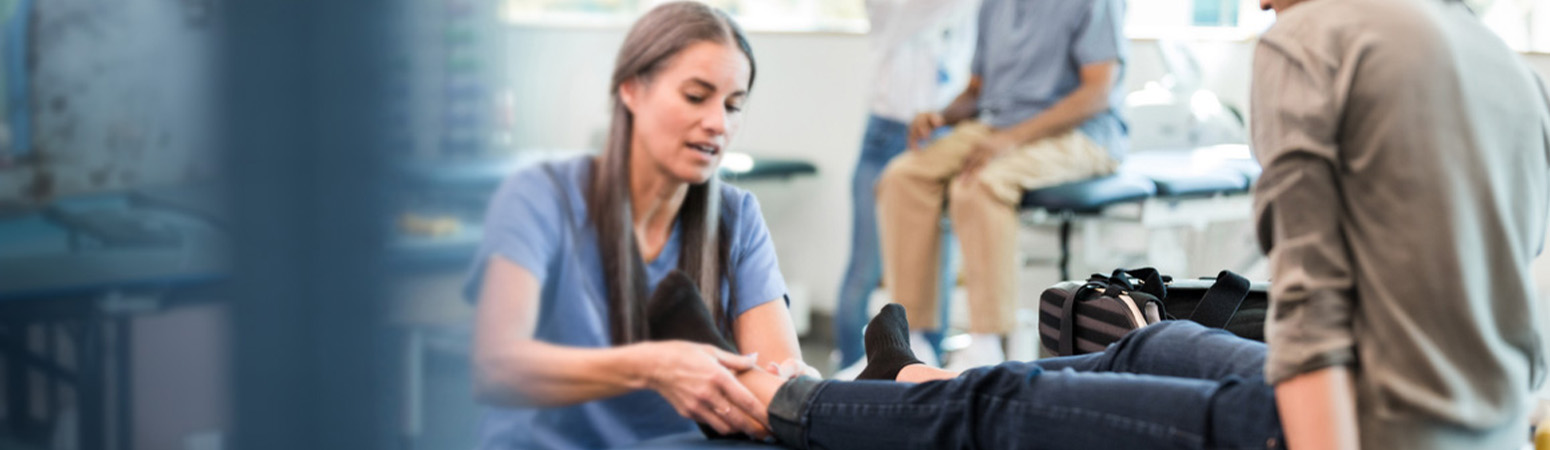 Occupational therapist working with a patient in the ED, illustrating the benefits of OT services in emergency care.