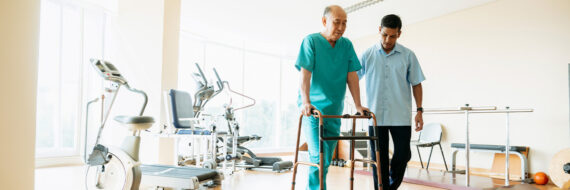 Older adult practicing balance exercises with a physical therapist, focusing on fall prevention and STEADI principles.