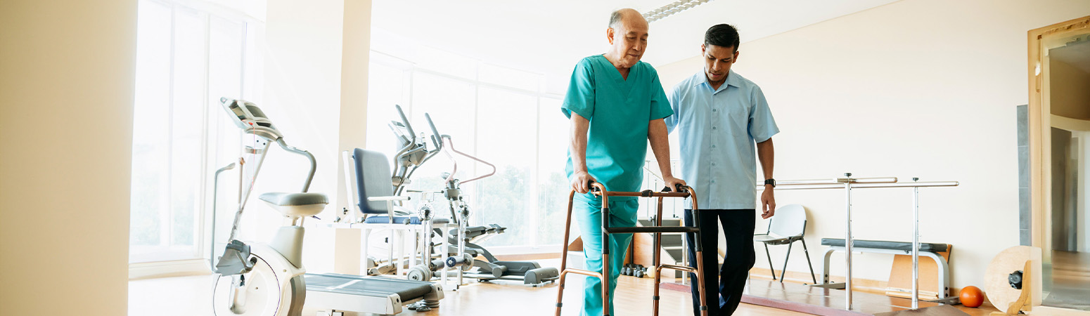 Older adult practicing balance exercises with a physical therapist, focusing on fall prevention and STEADI principles.