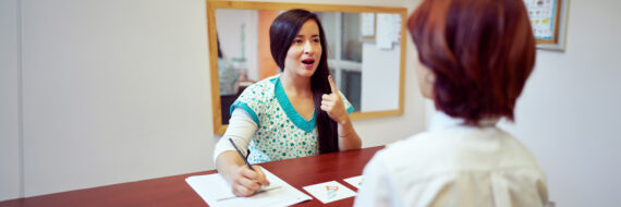 Speech-language pathologist working with a patient on verbal articulation, demonstrating techniques related to SLP CPT codes and accurate therapy documentation.