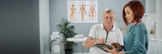 Healthcare provider guiding a patient through treatment options on a digital device.