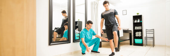 Physical therapist assisting patient in a balance exercise, demonstrating use of Berg Balance Test PDF in a clinical setting.