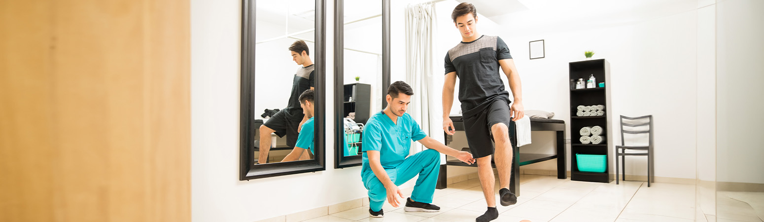 Physical therapist assisting patient in a balance exercise, demonstrating use of Berg Balance Test PDF in a clinical setting.